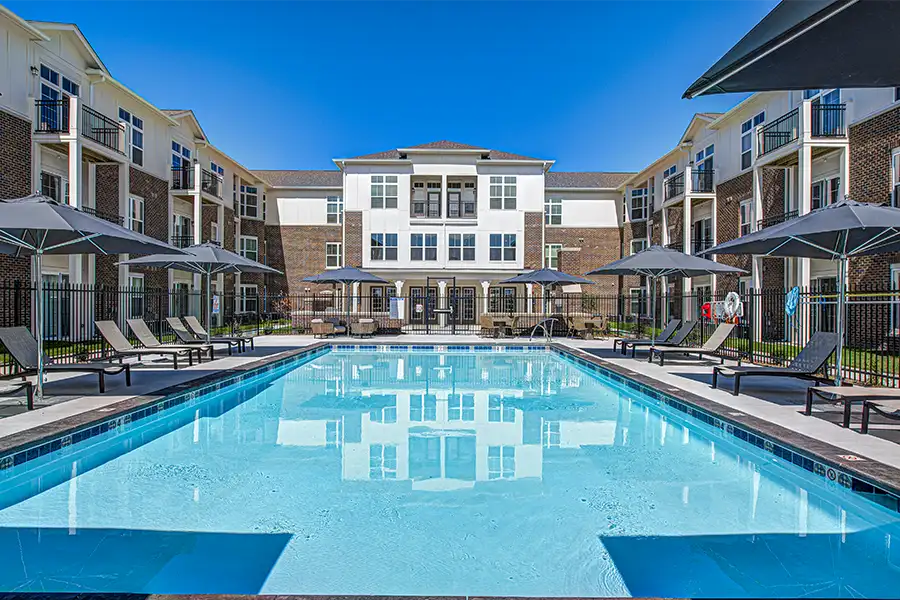 Pristine pool surrounded by apartment buildings at The State Apartments.